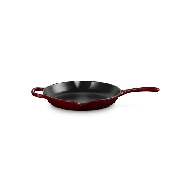 Cast iron skillet with handle and helper handle inner surface is smooth with a subtle sheen