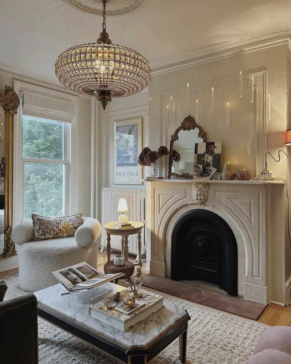 A white living room with a vintage chandelier