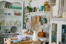 Stylish and sunny interior of kitchen space with small wooden table at the photo studio.