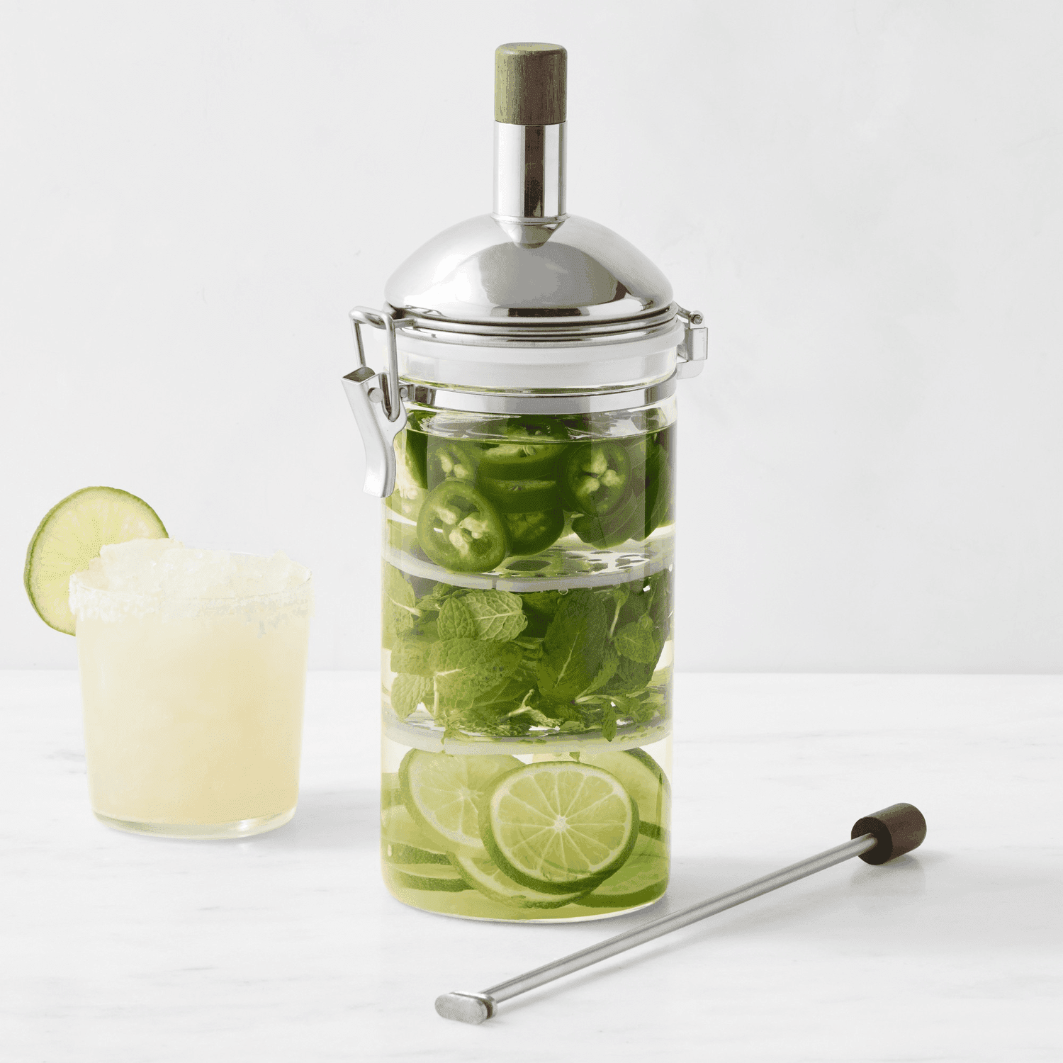 Clear glass beverage infuser with margarita. 