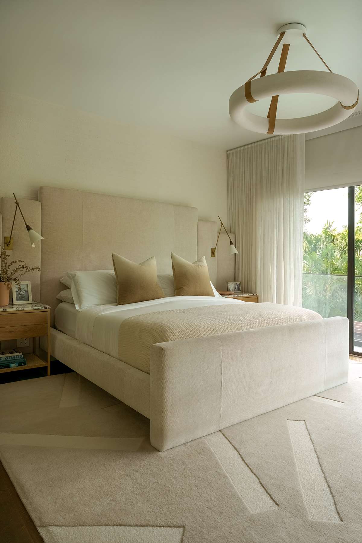 A neutral, primarily cream bedroom with a thick pile rug that has random dashes made from lower pile knots. 