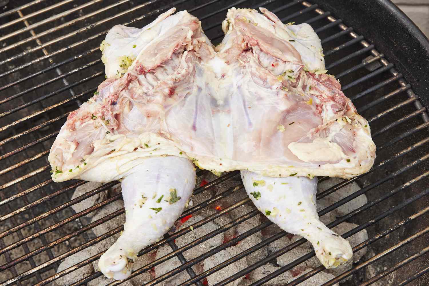Spatchcocked chicken on grill