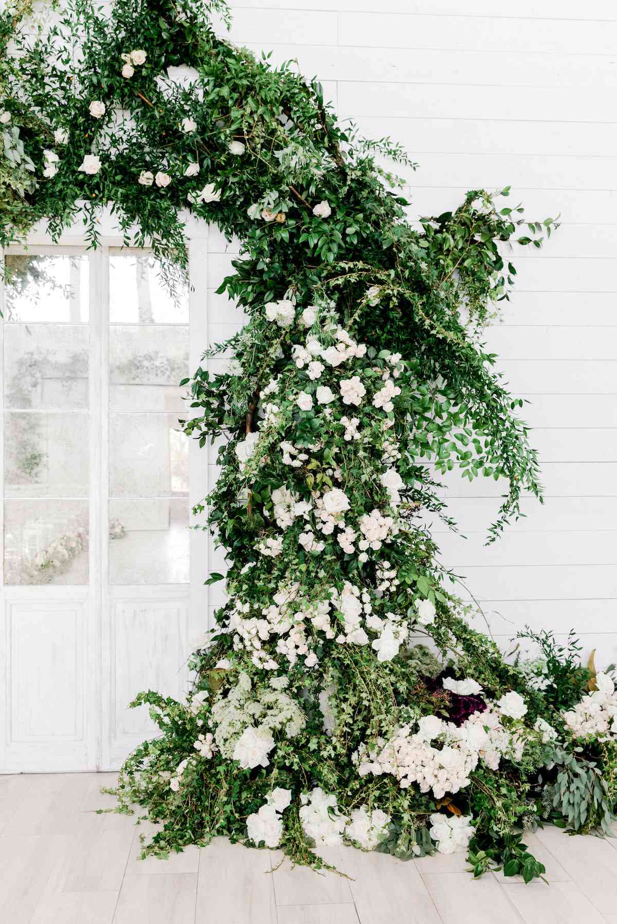 elegant white floral and greenery wedding arch