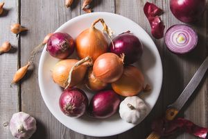 overhead view of bowl of onions and garlic