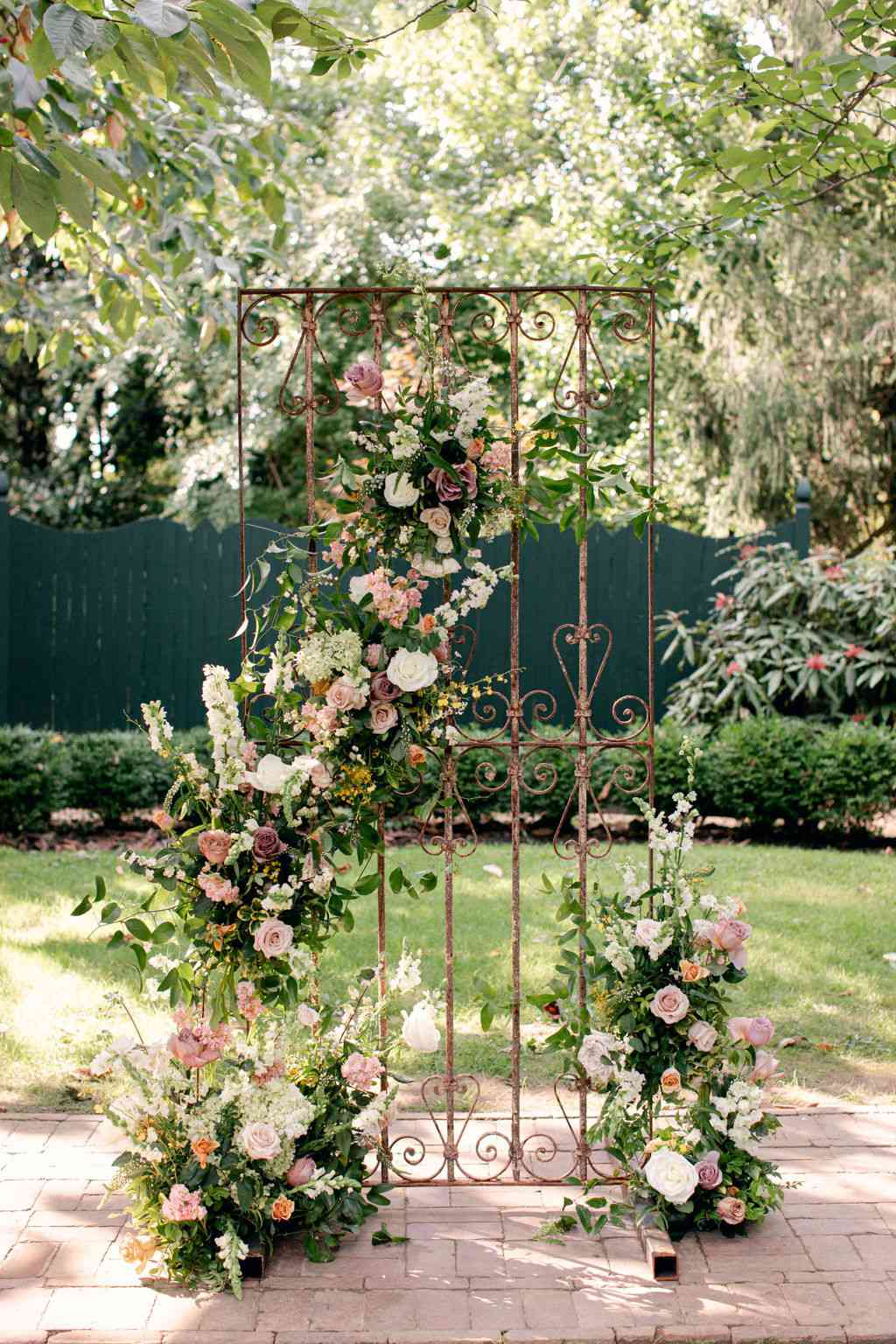 iron gate covered in floral decor wedding ceremony