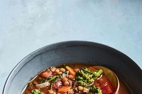 vegan lentil soup in bowl on blue table