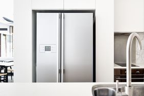 A modern kitchen with a stainless steel refrigerator and sink