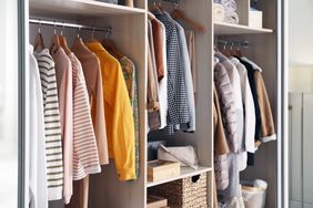 Organized wardrobe with hanging clothes and stored accessories