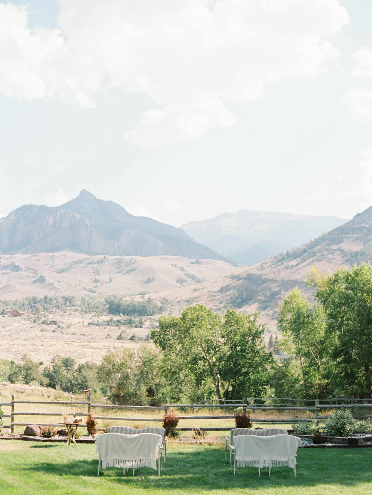 wedding ceremony white benches set up with mountain view
