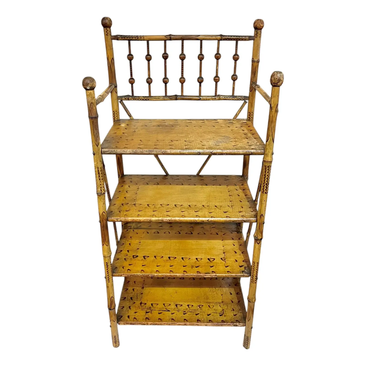 An antique bamboo etagere with four shelves and decorative details