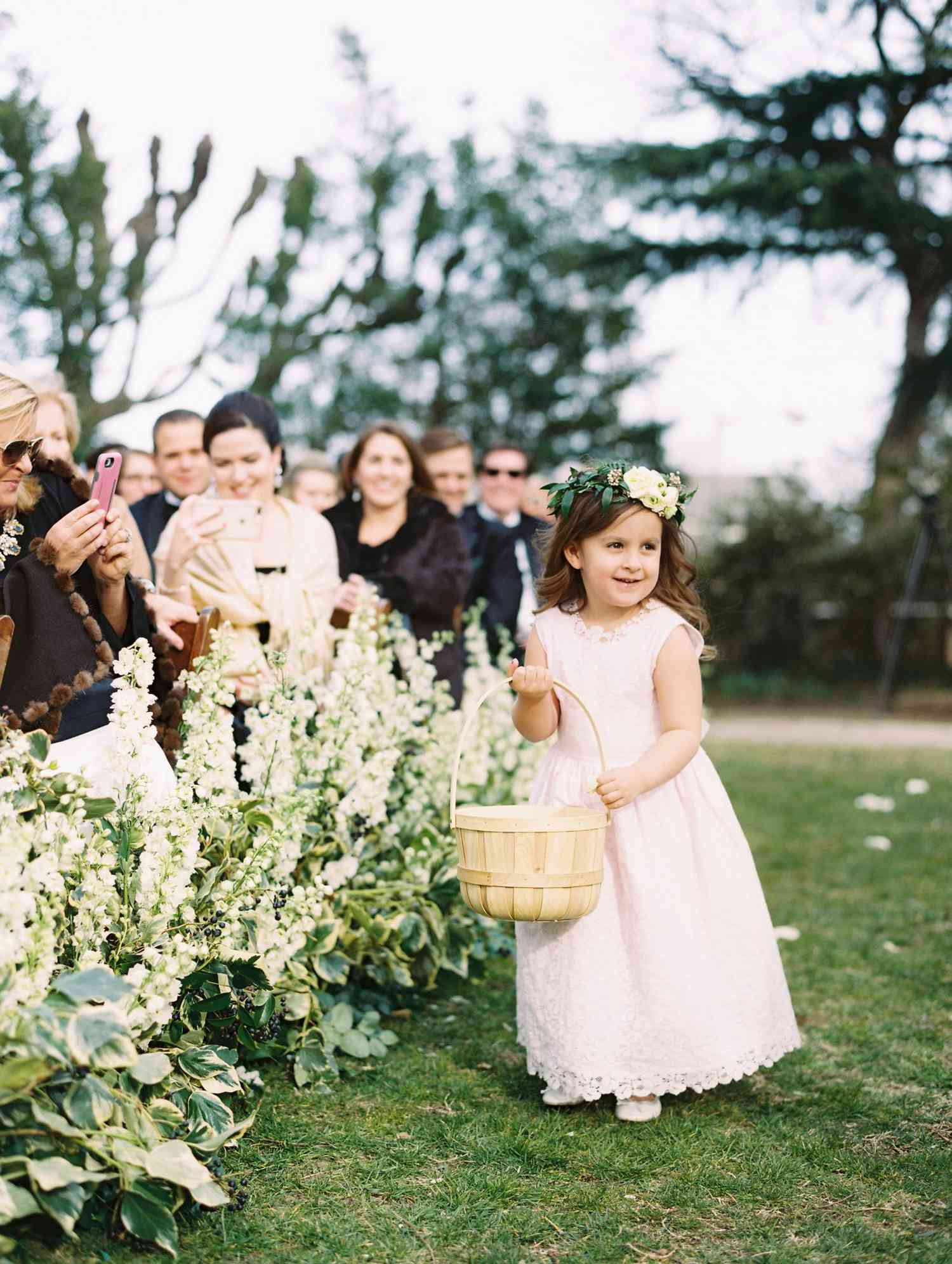 flower girl holding large wicker basket