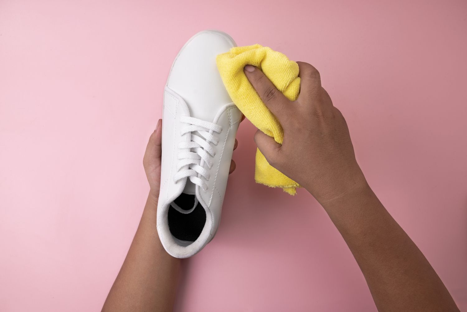 cleaning white sneakers with a microfiber cloth