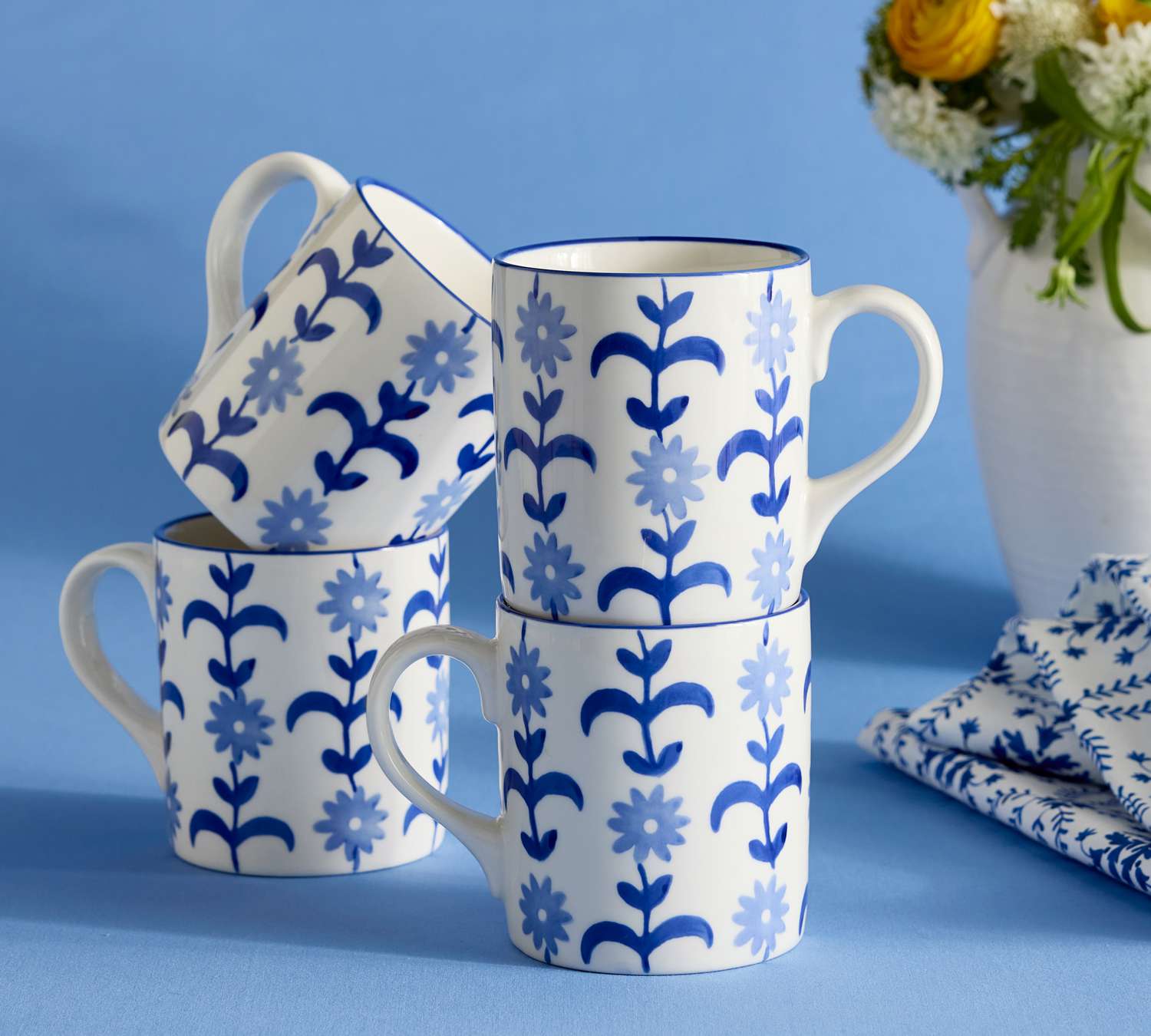 white and blue floral mugs