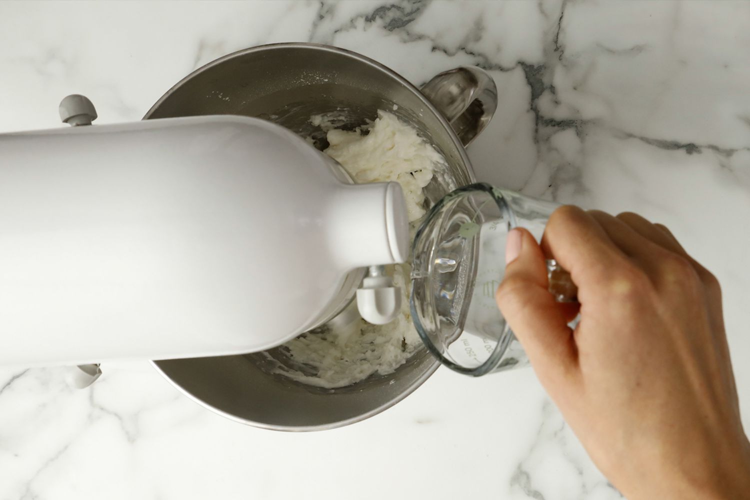 overhead view of someone adding water to a mixer