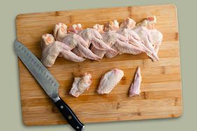 Raw chicken wings on cutting board