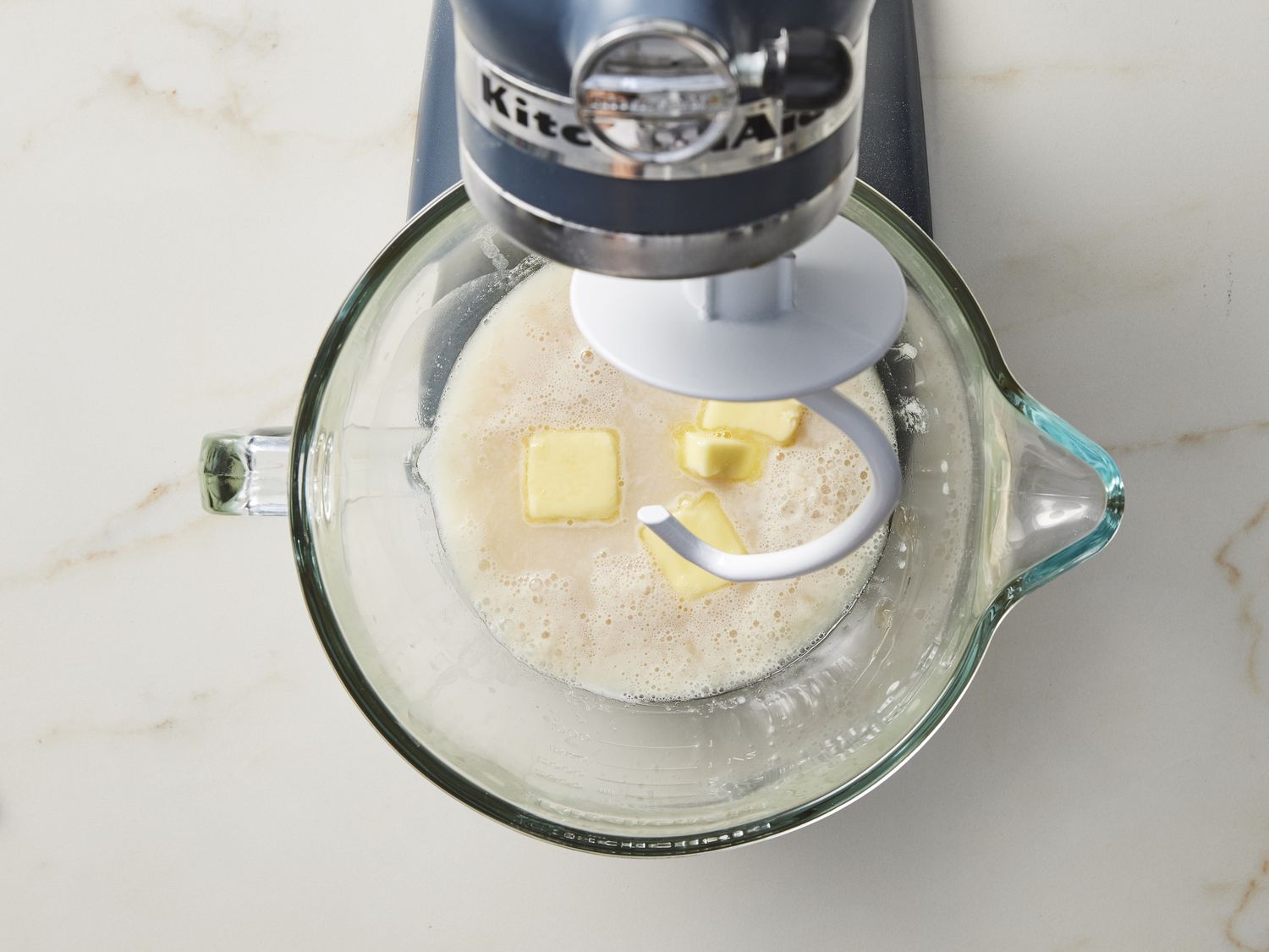 Yeast and butter in bowl under stand mixer