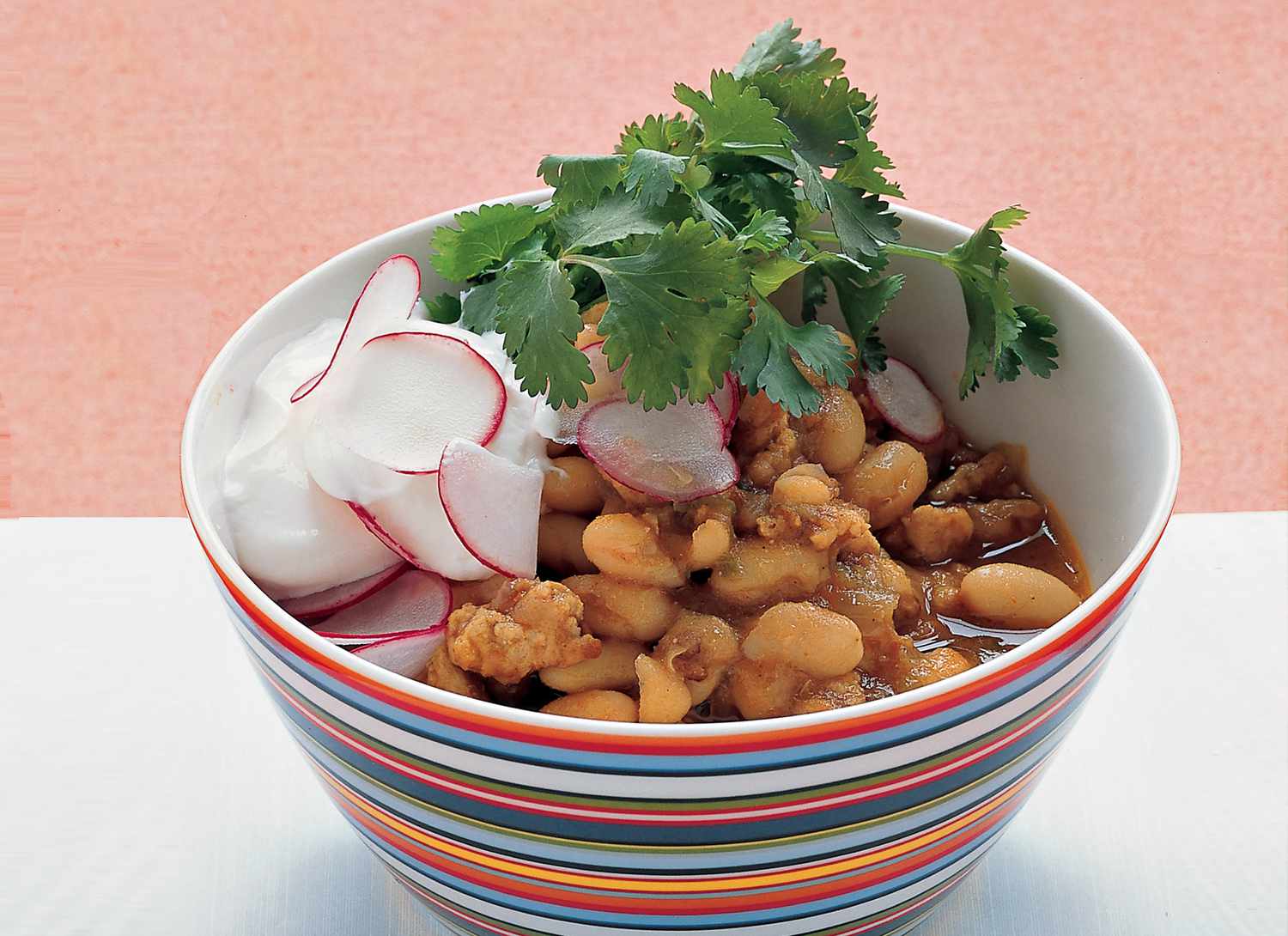 colorful bowl of turkey chili with condiments 