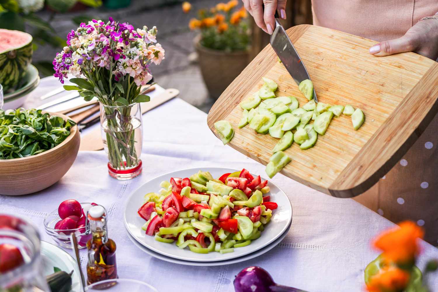 Prepping seasonal vegetables for outdoor dinner party