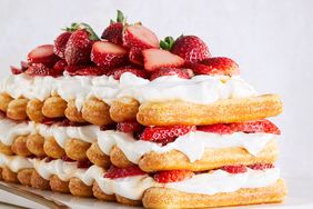 strawberries-and-cream stack cake topped with fresh strawberries