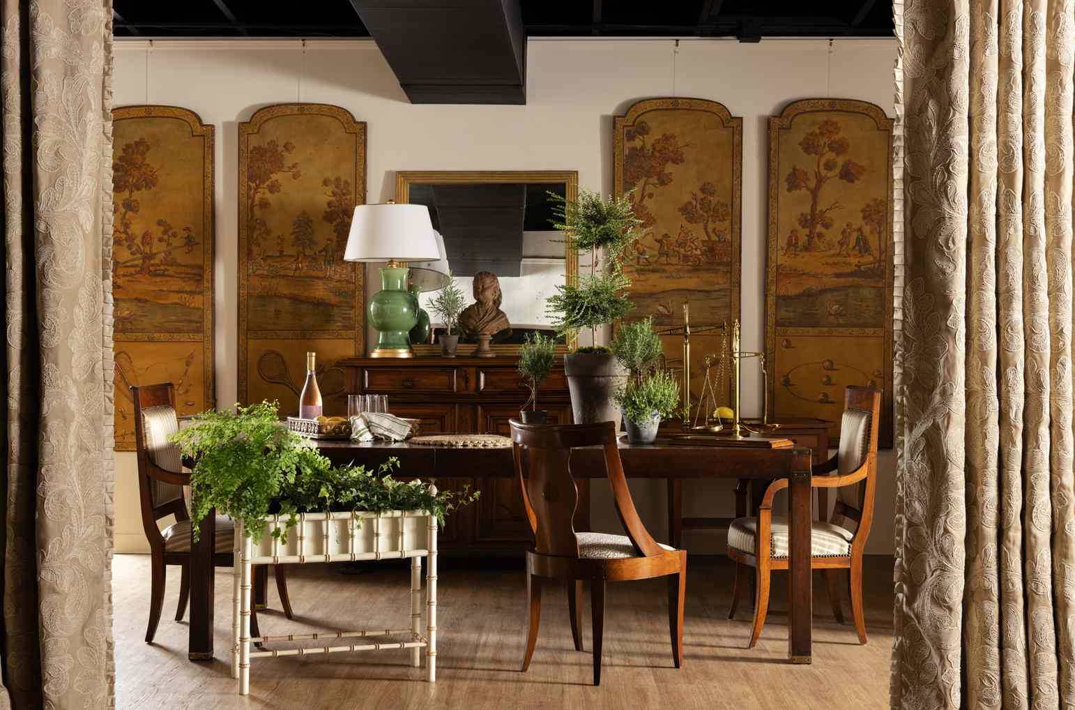 Elegant showroom with a dining table chairs plants and decorative panels