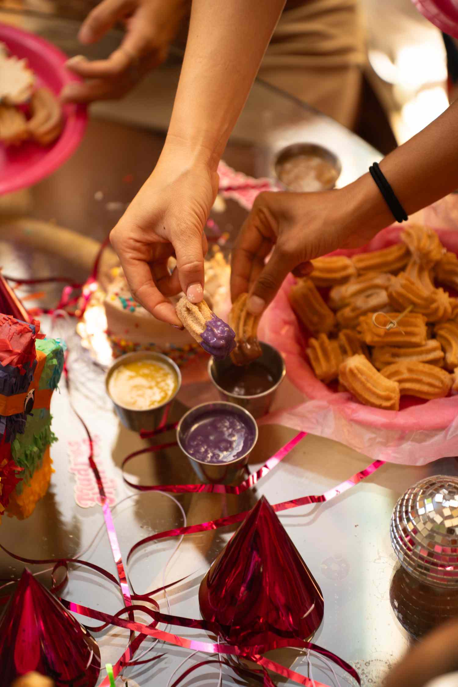 vegan poi churros being dipped in sweet sauce