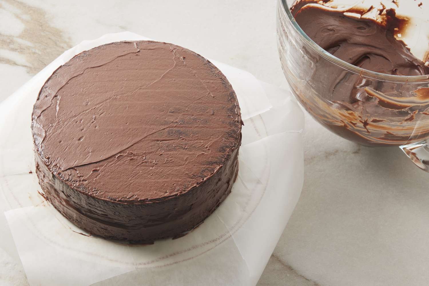 Chocolate cake on cake stand with frosting
