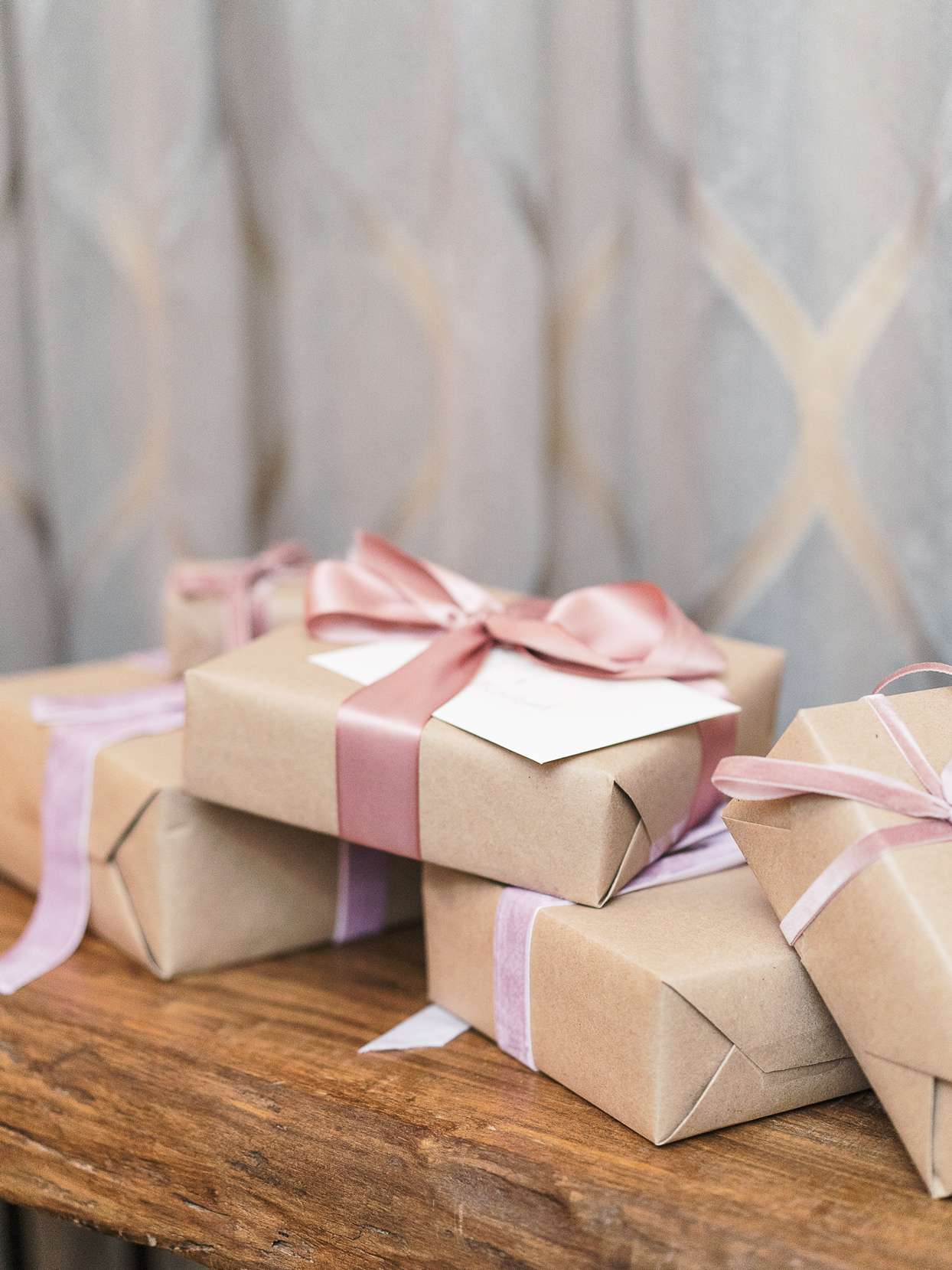 reception gifts in brown wrapping with pink and purple ribbon bows