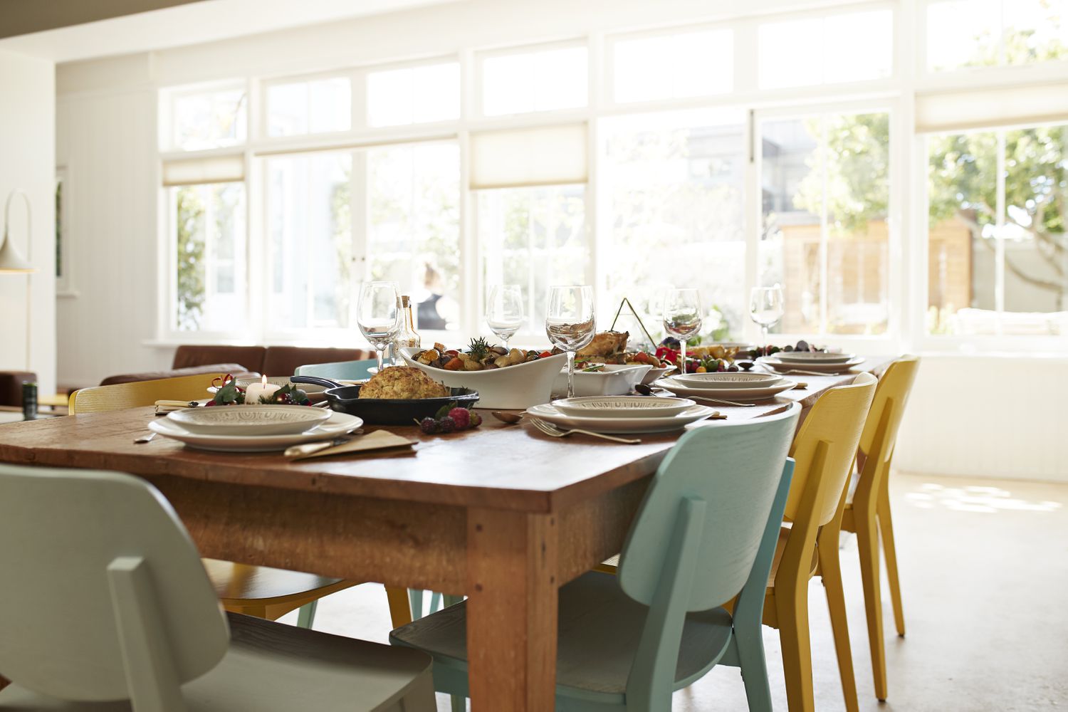 Empty chairs arranged by dining table at home