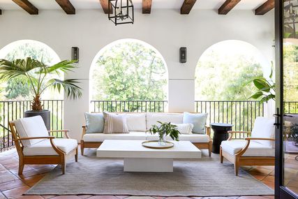 Veranda with archway door, couches, and chairs