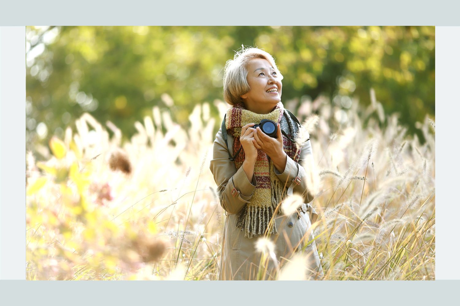 woman holding camera in a field