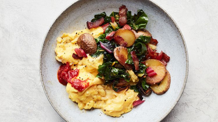 bacon potato and swiss chard scramble served on grey plate