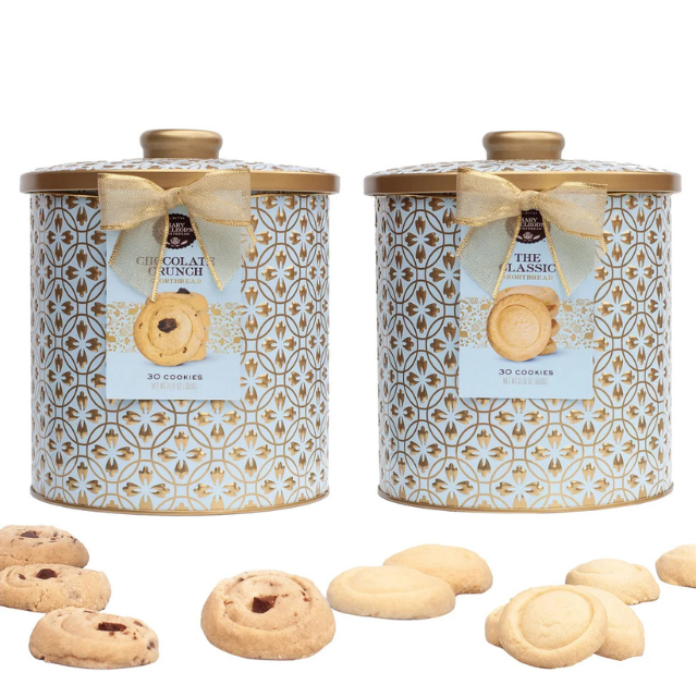 Two decorative tins of cookies with bows and a variety of cookies displayed in front