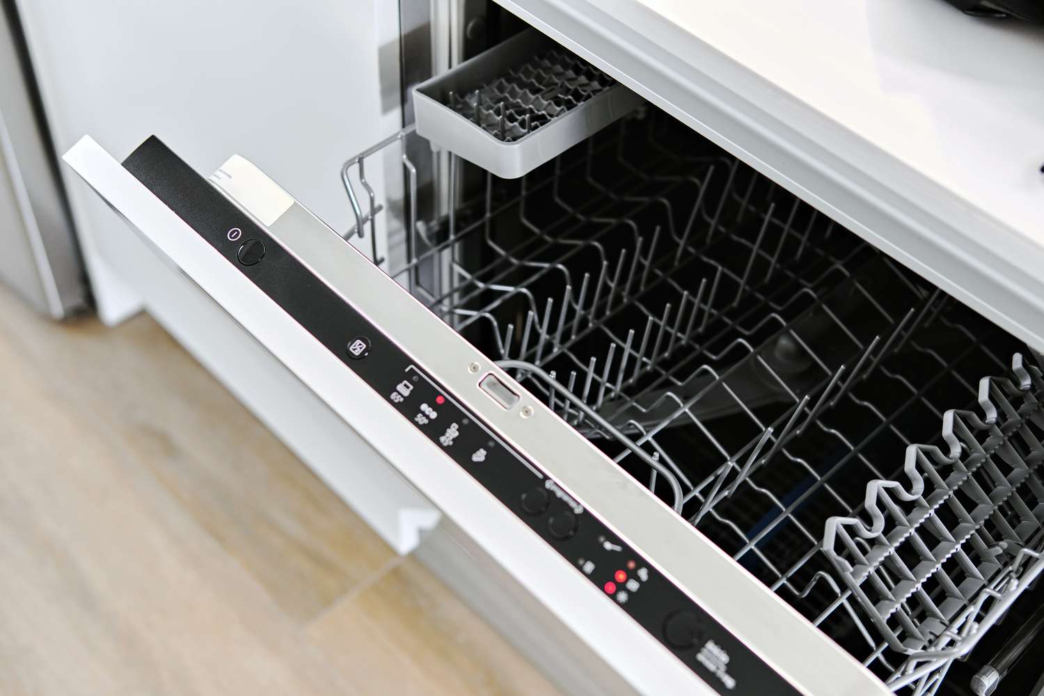 Open dishwasher with visible racks and control panel