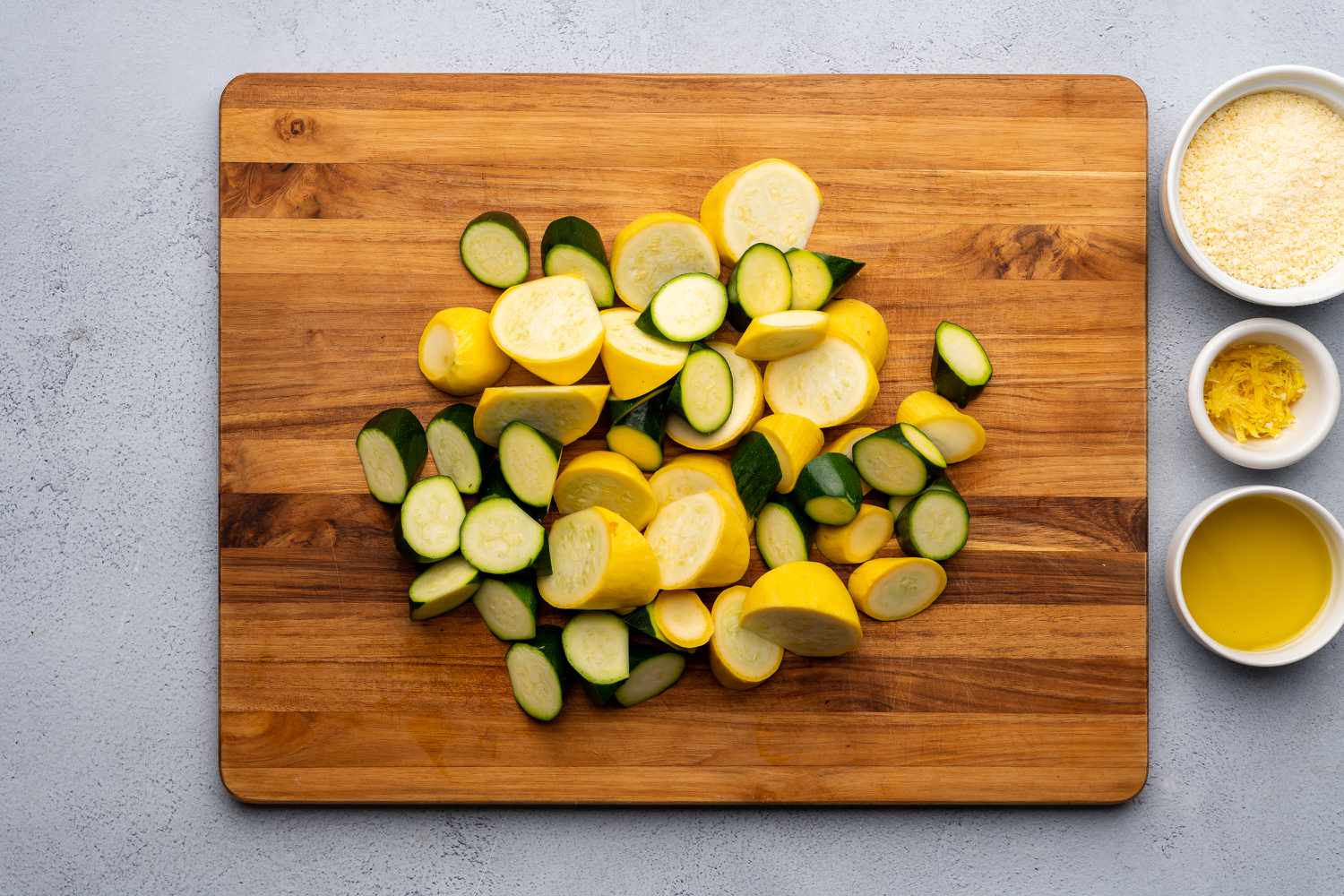 sliced summer squash and zucchini on a chopping board