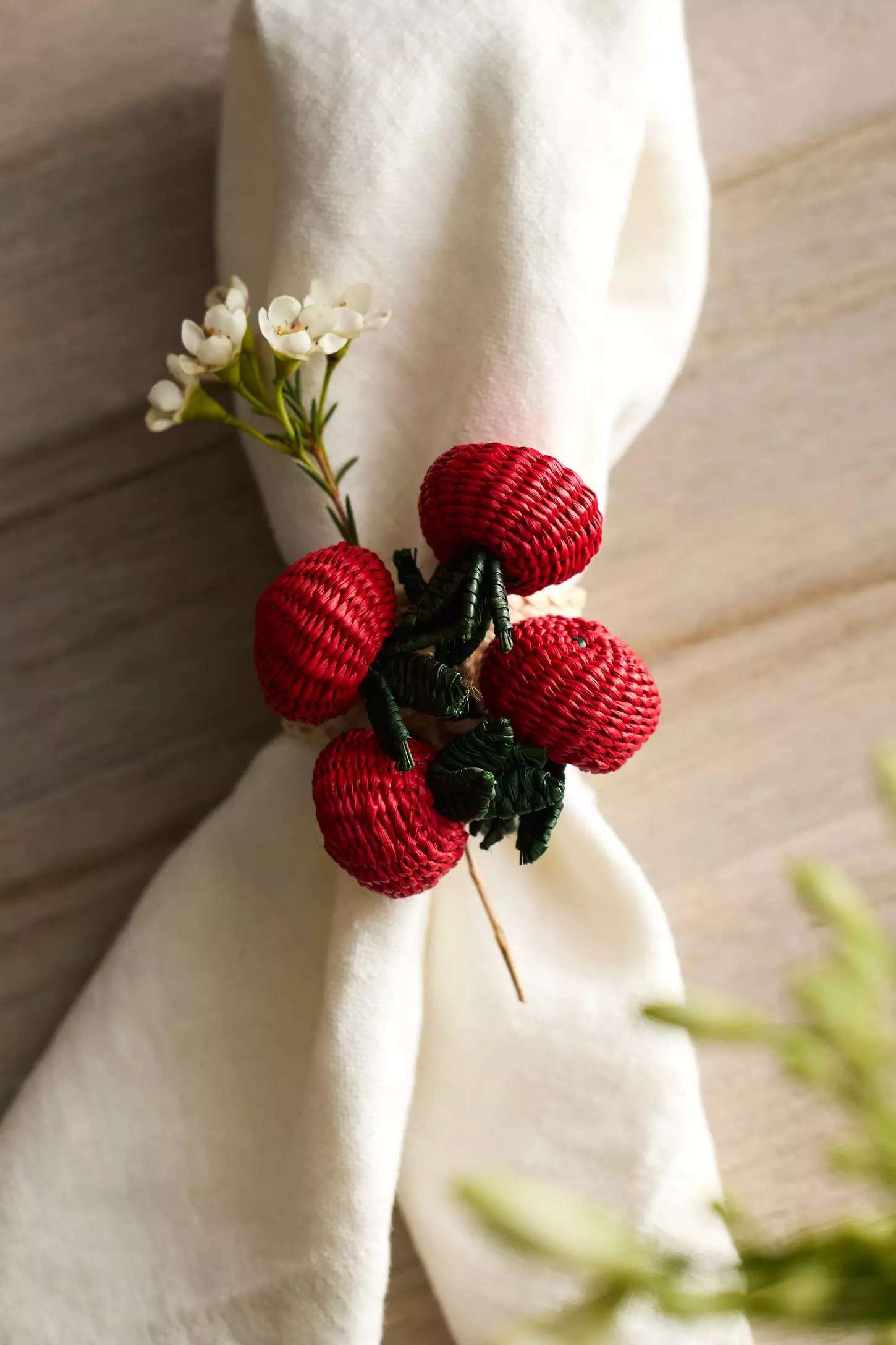 Decorative napkin tie with tomatoes and greenery 