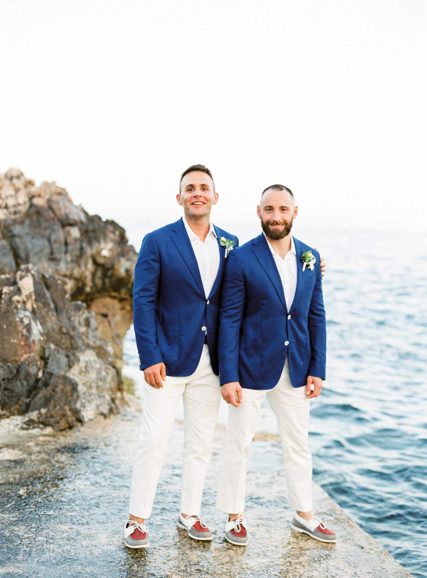 grooms wearing all white suits with royal blue jackets