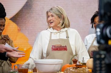 decorvow cooking on a Thanksgivingthemed show wearing an apron
