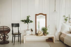 living room painted white with a mirror