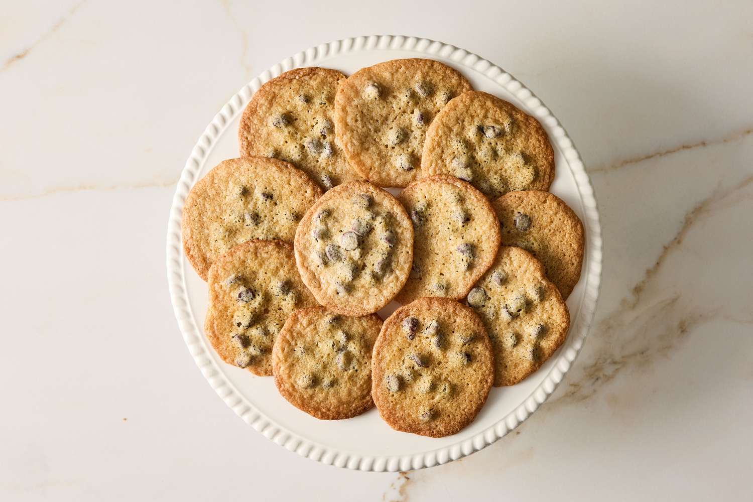 A plate of chocolate chip cookies arranged in a circle
