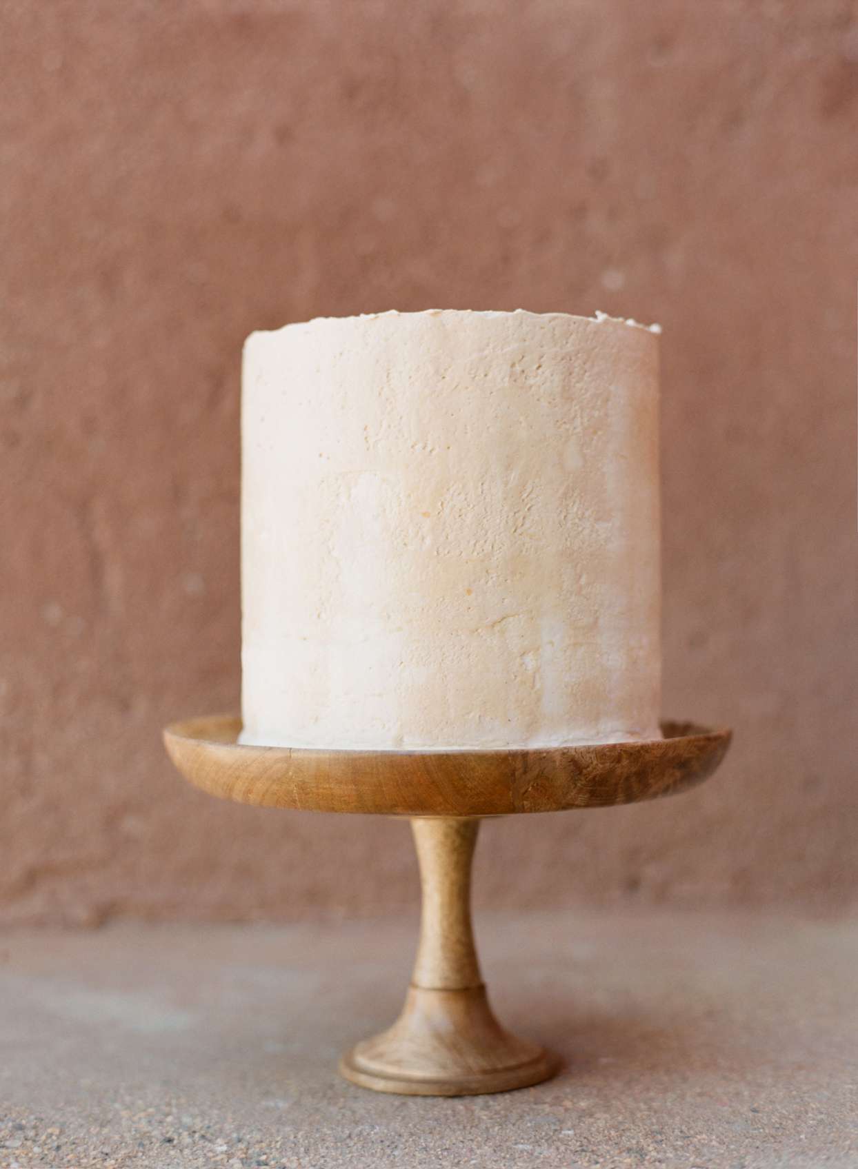 Small two-tiered simple frosted wedding cake