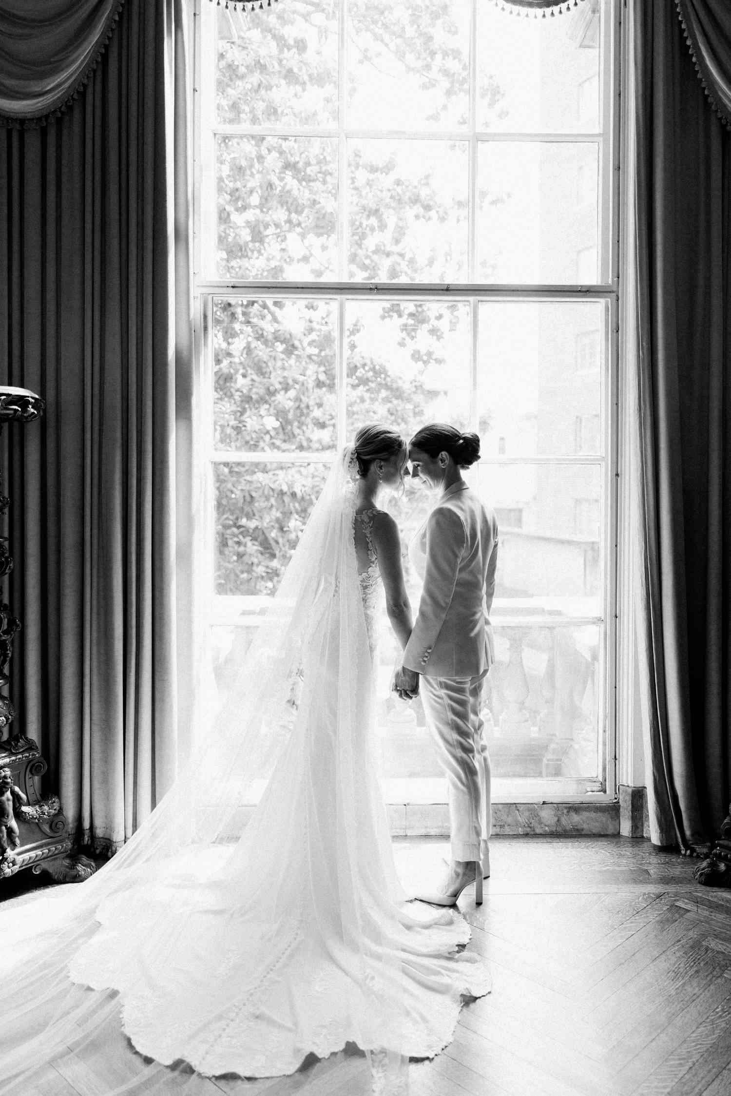 wedding couple in front of a window