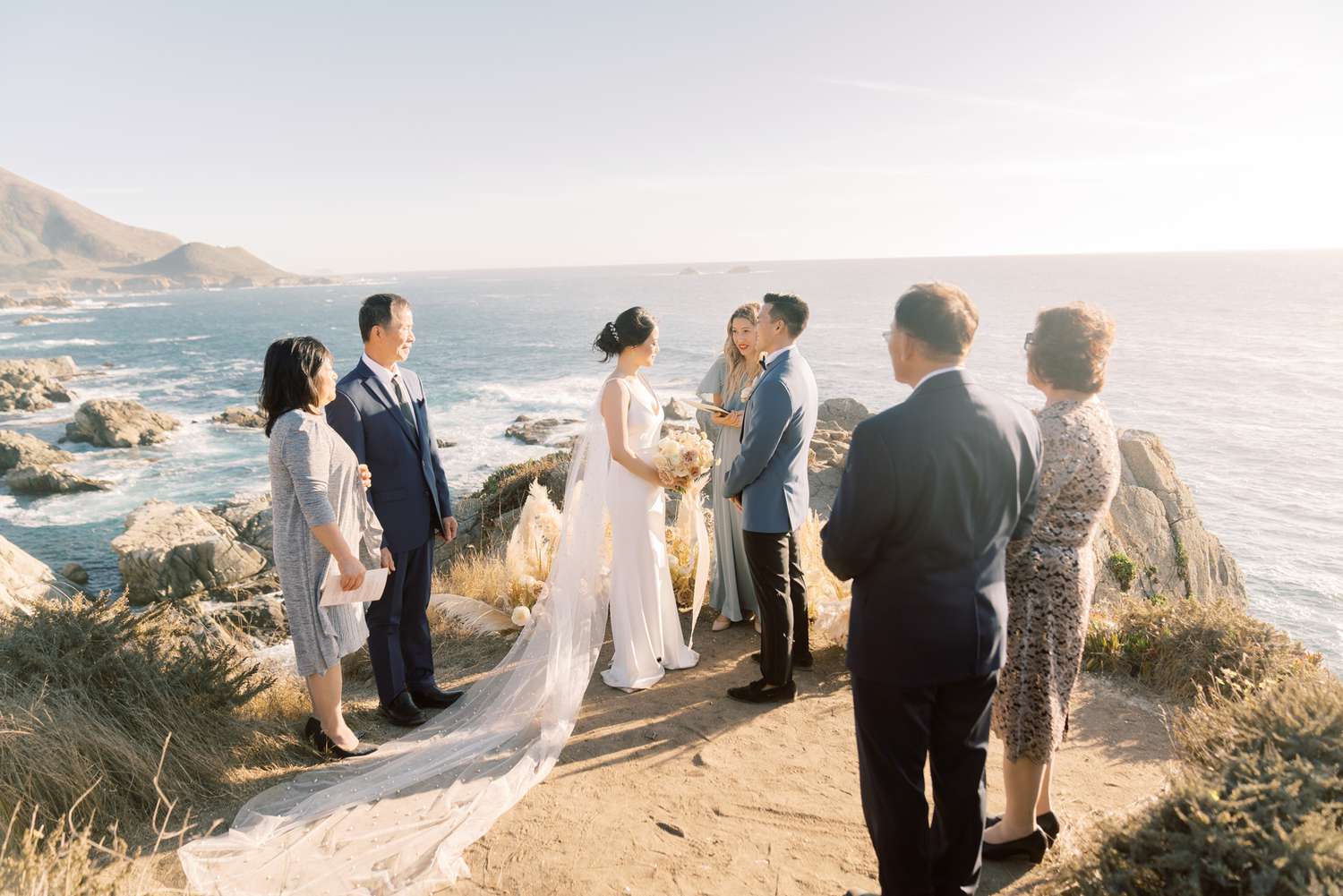 Bride and groom exchanging vows with parents present