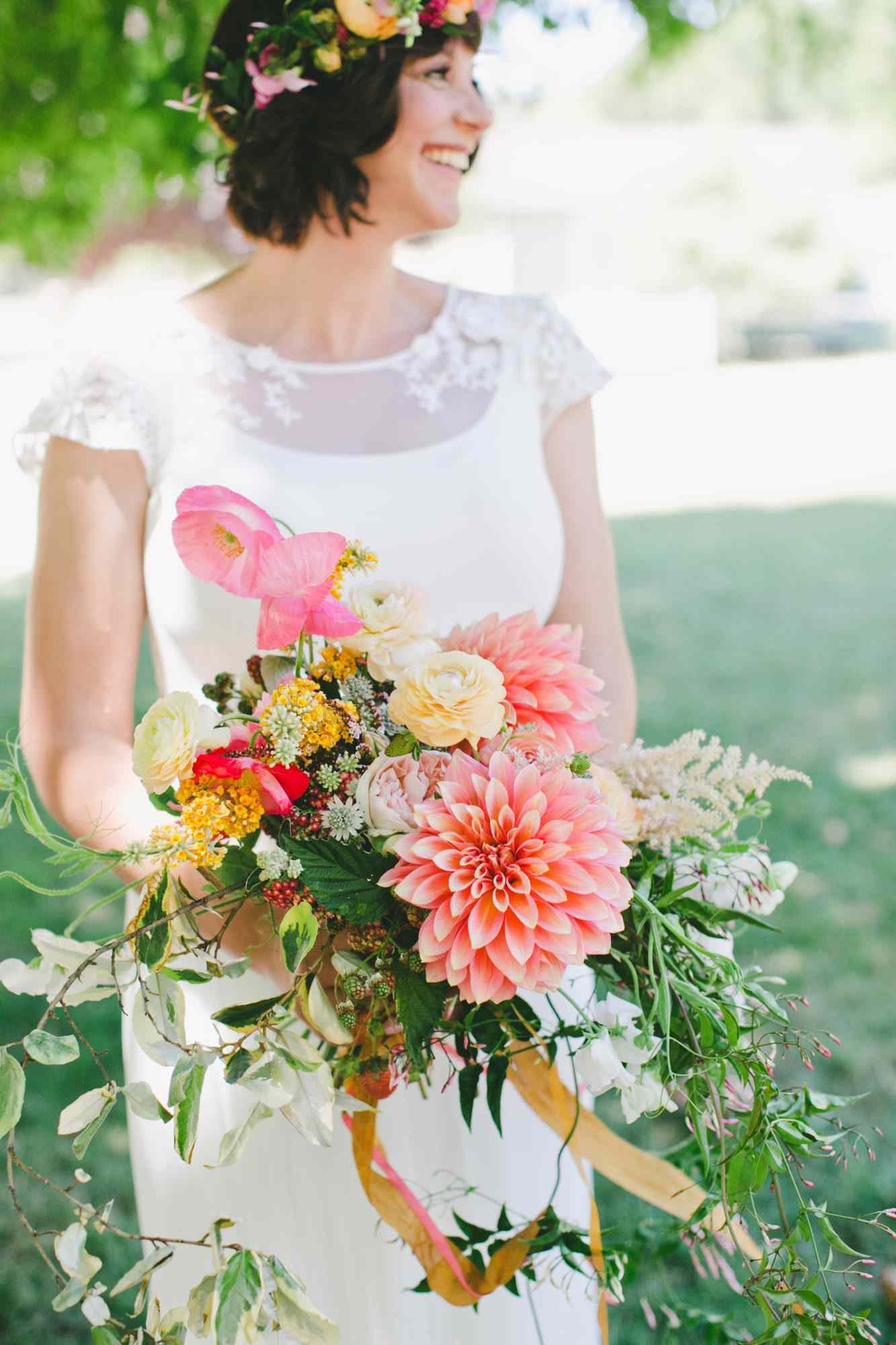 bride with dahlia bouquet orange yellow white