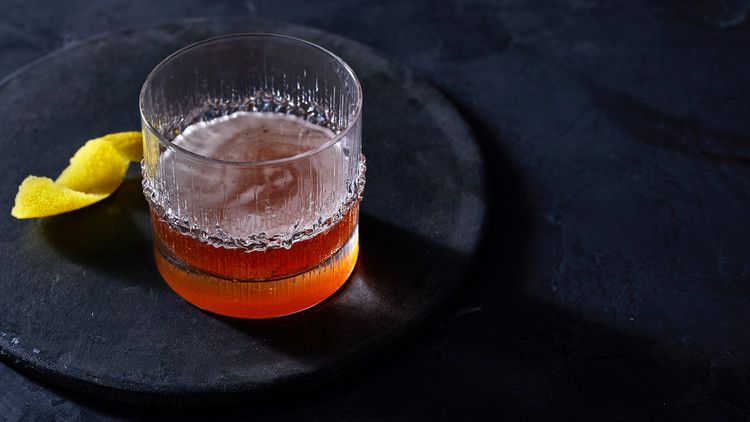 sazarac in rocks glass on black plate