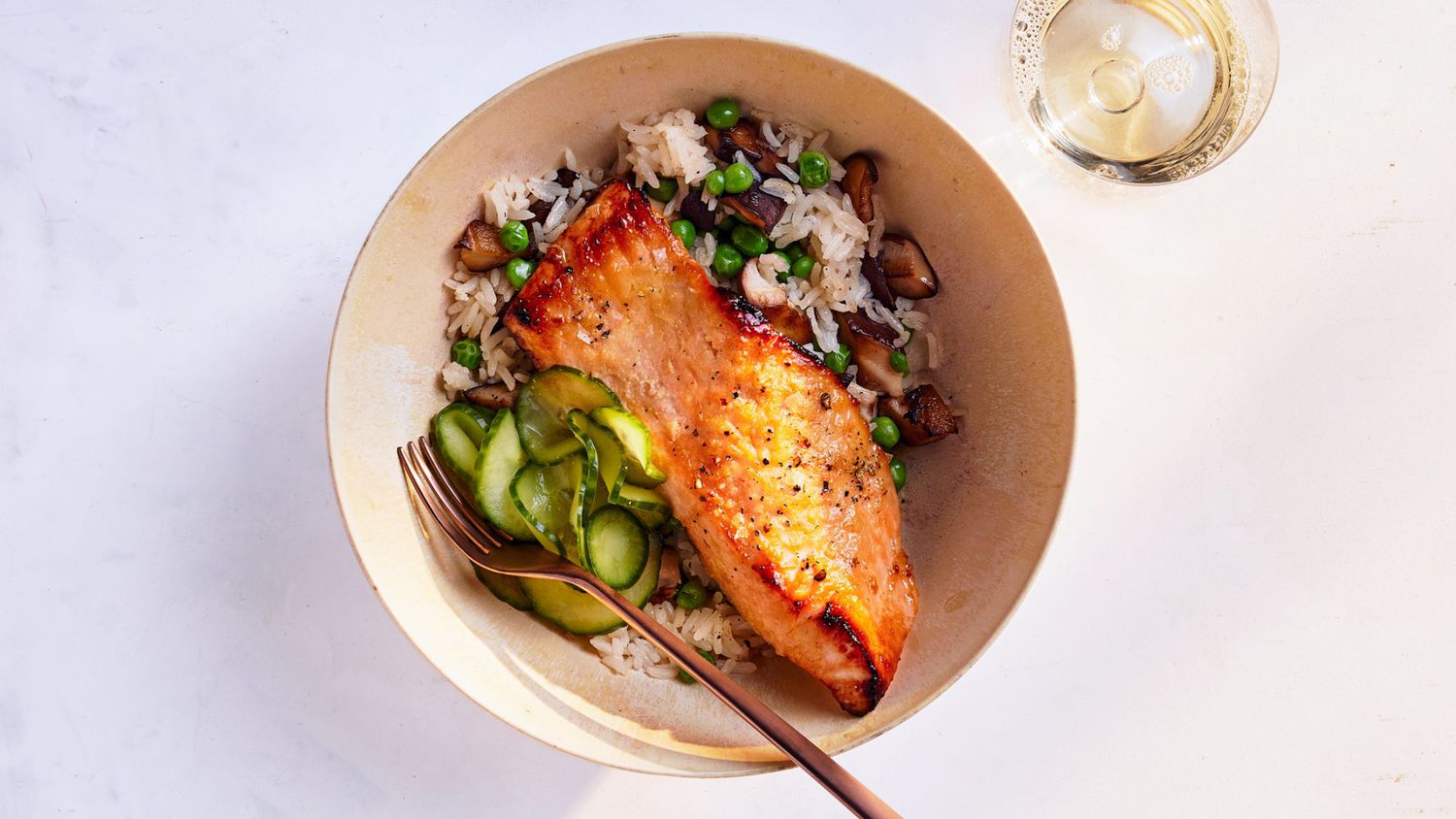 salmon-shiitake rice bowls served with cucumber