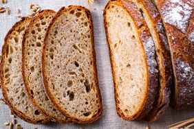 Slices of whole wheat sourdough bread on a cloth surface