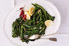 sprouting broccoli with peperoncini served with lemon wedges