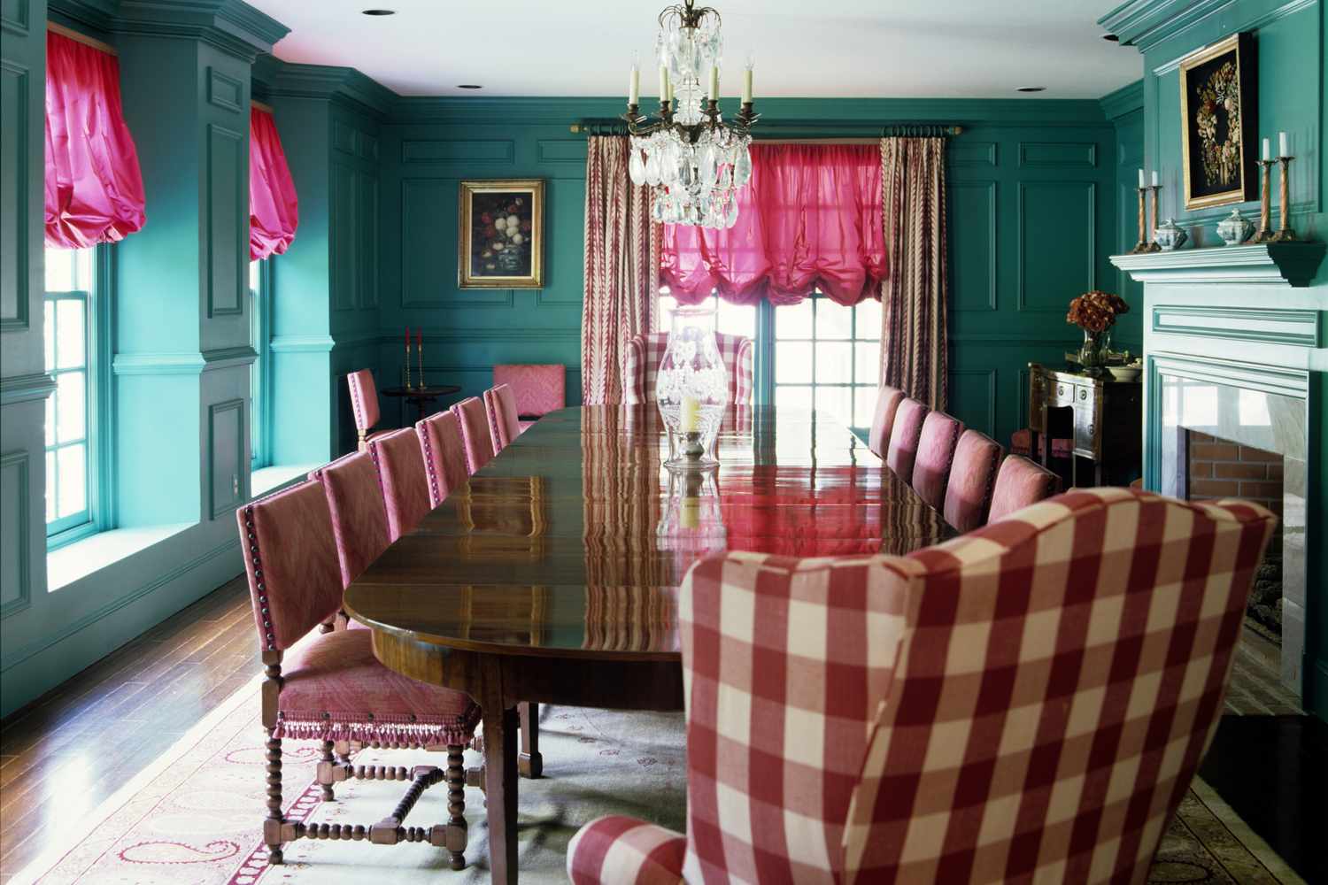 maximalist dining room with teal walls and pink accents
