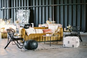 lounge space with bold colored couches and black wicker chairs