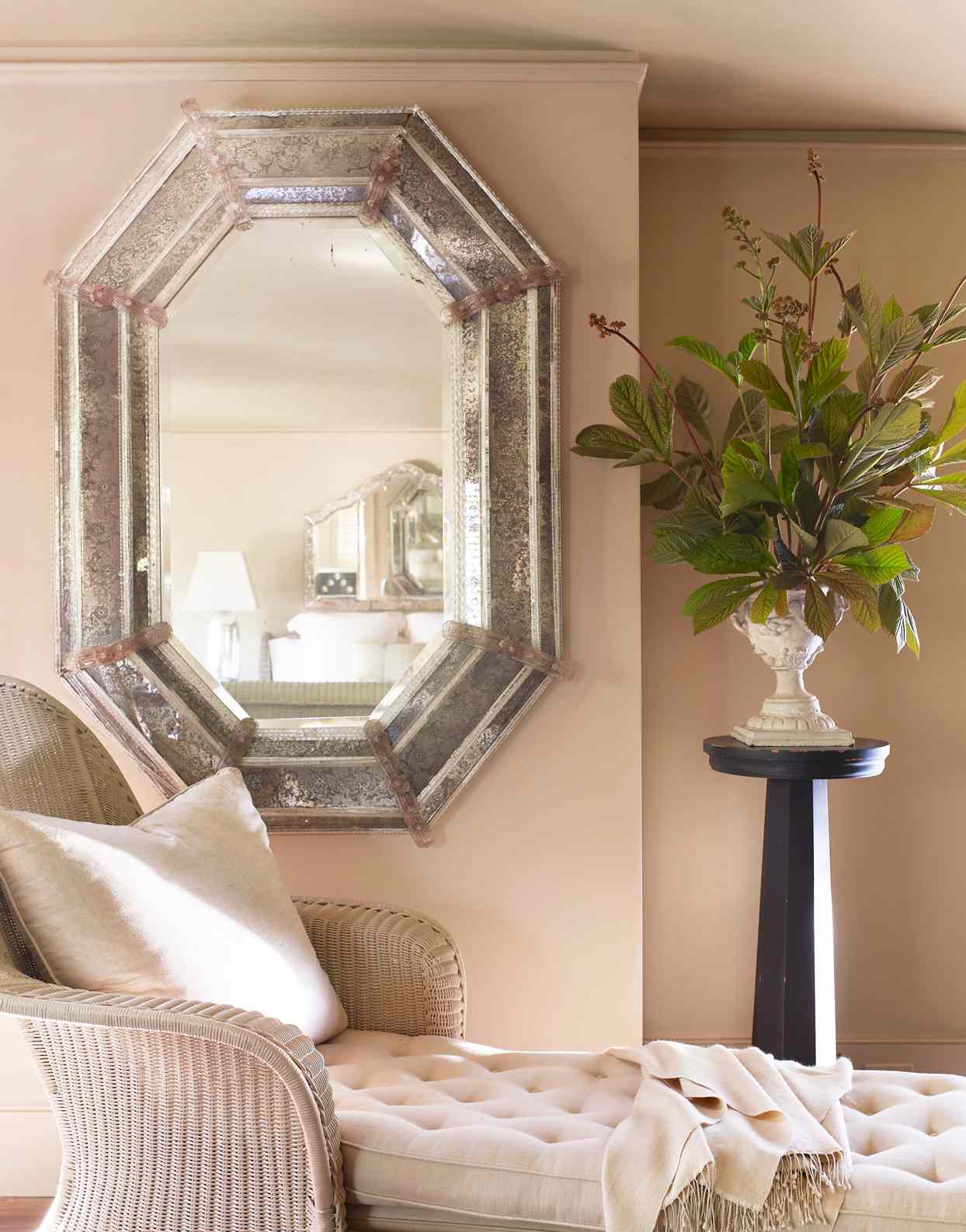 antique wicker chaise and venetian mirror